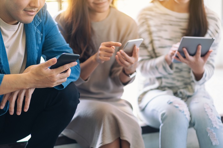 Group of people using and looking at mobile phone and tablet pc