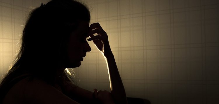 Person thinking in dark room: research on autism and self talk