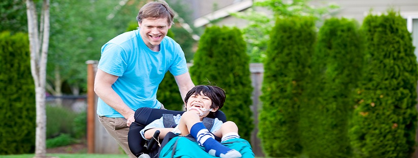 Father running with disabled son in wheelchair