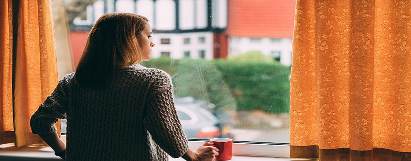 Person at home looking out window