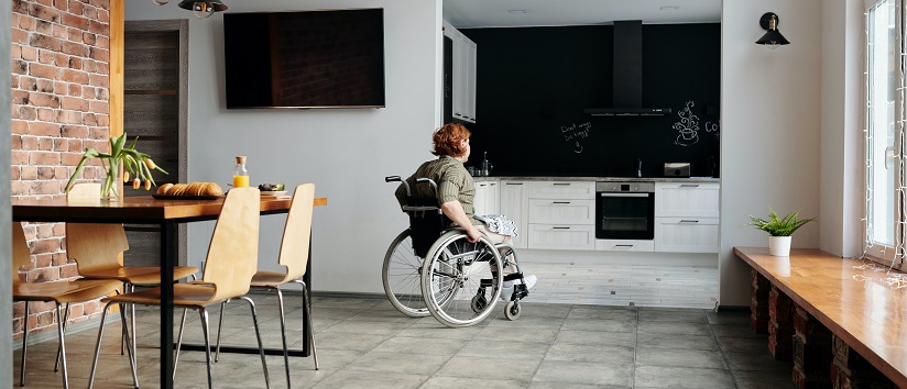 person in wheelchair at home