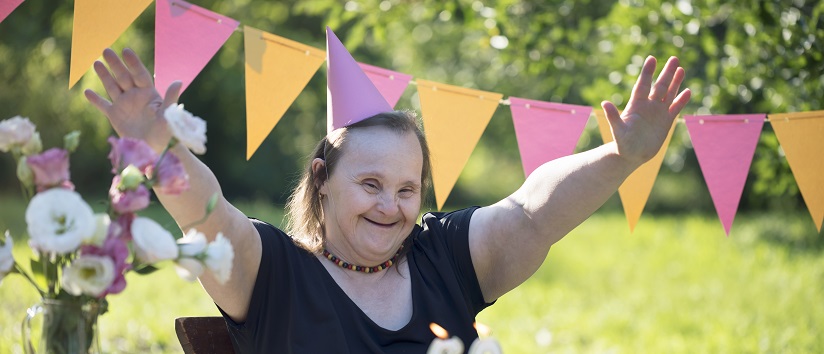 Woman with Down syndrome celebrating birthday party.