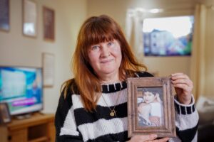 Mother holding picture of son
