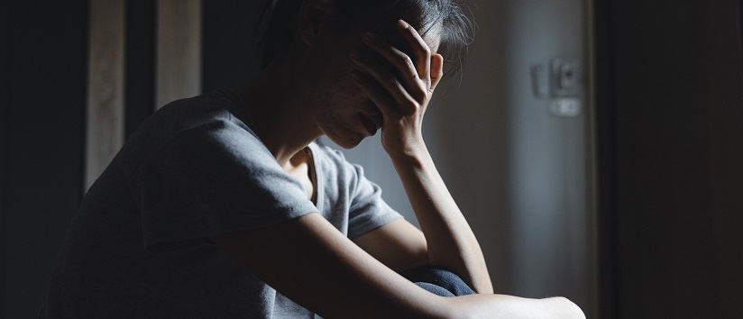 Sad woman sitting alone, woman on the bed, stress