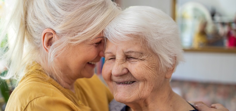 Carer looking happy with elderly mother